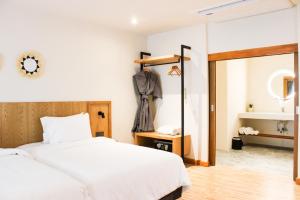 a bedroom with two beds and a mirror at Baan Haad Ngam Boutique Resort in Chaweng