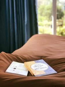 a book sitting on top of a bed at TIGOLD Homestay DALAT INN in Da Lat