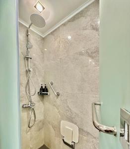a bathroom with a shower with a glass door at Relaxing 1BR Suite in La Mirada in Mactan