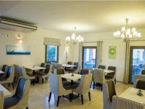 a dining room with tables and chairs in a restaurant at OMIROS HOTEL in Mesaria