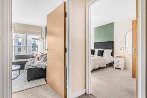 a bedroom with a bed and a large mirror at Luxury balcony in Colindale in Hendon