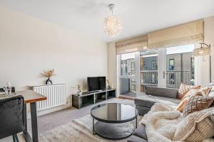 a living room with a couch and a table at Luxury balcony in Colindale in Hendon