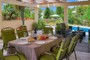 a table and chairs on a patio at Crassula Summer Villa with Private Pool in Kras