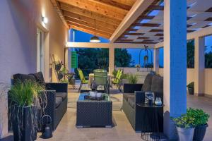 a patio with couches and tables and chairs at Crassula Summer Villa with Private Pool in Kras