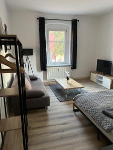 a living room with a couch and a table at Apartment 4 - Haus Lausitzring in Annahütte