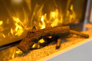 a piece of wood in front of a fireplace at Schwarzwald Chalet Achern in Achern +5 photos