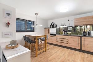 a kitchen with a table and a dining room at Schwarzwald Chalet Achern in Achern