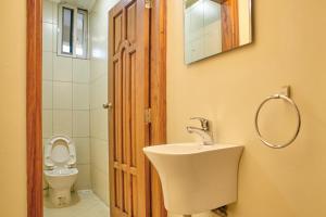 a bathroom with a sink and a toilet at Hil Venture in Arusha