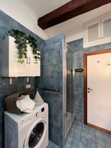 a washing machine in a bathroom with a shower at LaMarina in Camogli