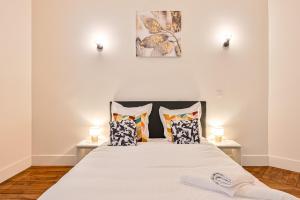 una camera da letto con un grande letto con cuscini di Magnifique Appartement de luxe & familial avec Parking - Paris 16 a Parigi