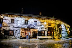 an old stone building with christmas lights on it at Lovna sreshta in Bansko