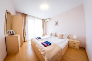 a bedroom with a large bed and a window at Prestige Fort Beach - Full Board in Sveti Vlas