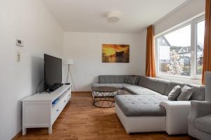 a living room with a couch and a tv at Villa Ennert in Winterberg