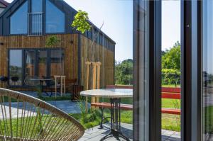 a house with a view of a patio with a table at Krynica Family House in Krynica Morska