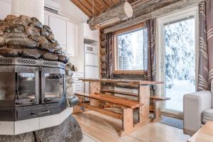 a living room with a stove and a window at Ruka Inn in Ruka