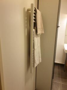 a towel is hanging on a refrigerator door at Studio proche rer e in Rosny-sous-Bois