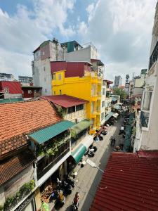 an overhead view of a city street with a yellow building at Old Quarter Autumn To Tich Ha Noi in Hanoi +173 photos