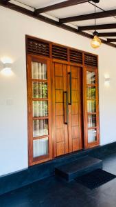 un armario de madera con puertas de cristal en la pared en Mellow Yellow, en Ahangama