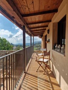 a balcony of a house with chairs on it at Casa Del Ingles - Luxury Private Village & Pool in Rural Valley in Pontevedra