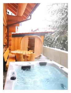 a hot tub on the patio of a house at DAS Chalet mit Schlossblick in Wernigerode in Wernigerode