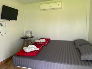 a room with a bed and a air conditioner at Srihome ยายศรีโฮมแอนแคมป์ปิ้ง in Ban Don Tum (1)
