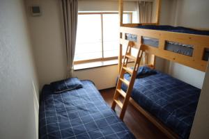 a bedroom with two bunk beds and a window at STAY Moiwayama201 in Sapporo