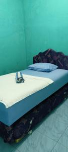 Voodi või voodid majutusasutuse Raja Ampat Sandy Guesthouse toas