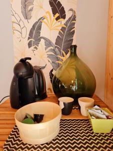 a wooden table with a vase and cups on it at Le Chalet Du Blanc Spa yoga in Aillon-le-Jeune