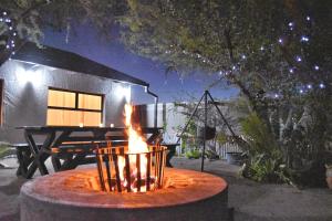 a fire pit in front of a tent at night at Knowhere Selfcatering Unit 1 in Omaruru
