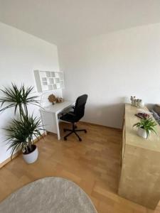 um escritório com uma secretária, uma cadeira e uma mesa em Ruhige 3 Zimmer - Ferienwohnung in der Rüti mit traumhafter Aussicht em Herisau