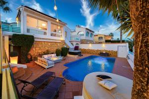 a house with a swimming pool in front of a house at Villa Vega Luxury in Cautivador