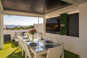 a table and chairs on a patio with a view at Villa Vega Luxury in Cautivador