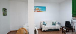 Μια τηλεόραση ή/και κέντρο ψυχαγωγίας στο habitación en un bajo 2 camas individual casa compartida