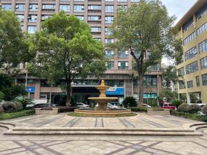 a fountain in the middle of a city at Park Inn by Radisson Wenzhou Longwan International Airport Wanda Plaza in Xingqianjie