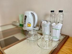 a counter with two glass bottles on top of it at Asian Hotel in Hat Yai