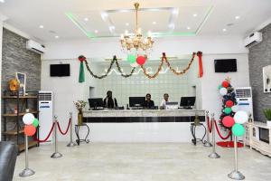 a lobby with a reception counter with balloons and people at VIEWPOINT HOTEL AND SUITES in Benin City