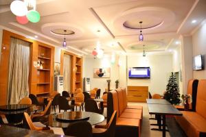a restaurant with tables and chairs and a christmas tree at VIEWPOINT HOTEL AND SUITES in Benin City