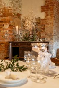a table with glasses and candles on a table at VILLA DI GRAZIELLA in Montisi