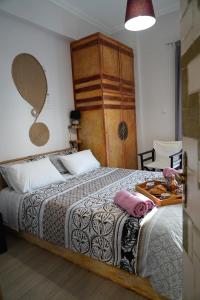 a bedroom with a bed with a tray of food on it at ΩκεανιςHouse 1 in Preveza