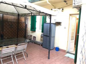a patio with two chairs and an umbrella at La casa di Gioia in Florence