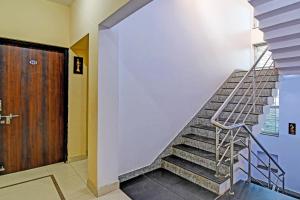 Una escalera con una barandilla de metal al lado de una puerta en OYO Archie Oasis, en Bhubaneshwar