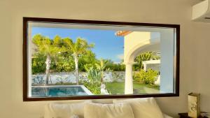 a large window in a room with a swimming pool at Exclusive Villa Valencia - Denia Els Poblets in Els Poblets