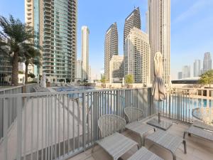 a balcony with chairs and a view of the city at Sophisticated and Trendy 2BDR In Forte Downtown in Dubai