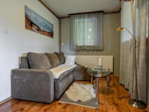 a living room with a couch and a glass table at Kuća za odmor Mateja Varaždinske Toplice in Varaždinske Toplice