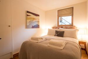 a bedroom with a large bed with two towels on it at La Ruinette - Cosy 1 Bed, 300m From Cable Car in Le Châble