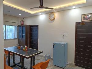 a dining room with a table and a clock on the wall at Narayan Palace- Luxury Homestay in Varanasi +18 photos