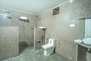 a bathroom with a toilet and a sink at Sandcastle Resort in Jaisalmer