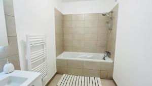 a bathroom with a tub and a sink at Appartement Citadella 1 Calvi in Calvi