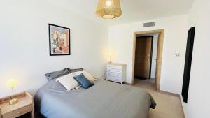 a bedroom with a bed and a dresser and a lamp at Appartement Citadella 1 Calvi in Calvi