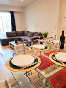 a living room with two tables with wine glasses at Appartement Nice avec balcon et parking privé in Nice